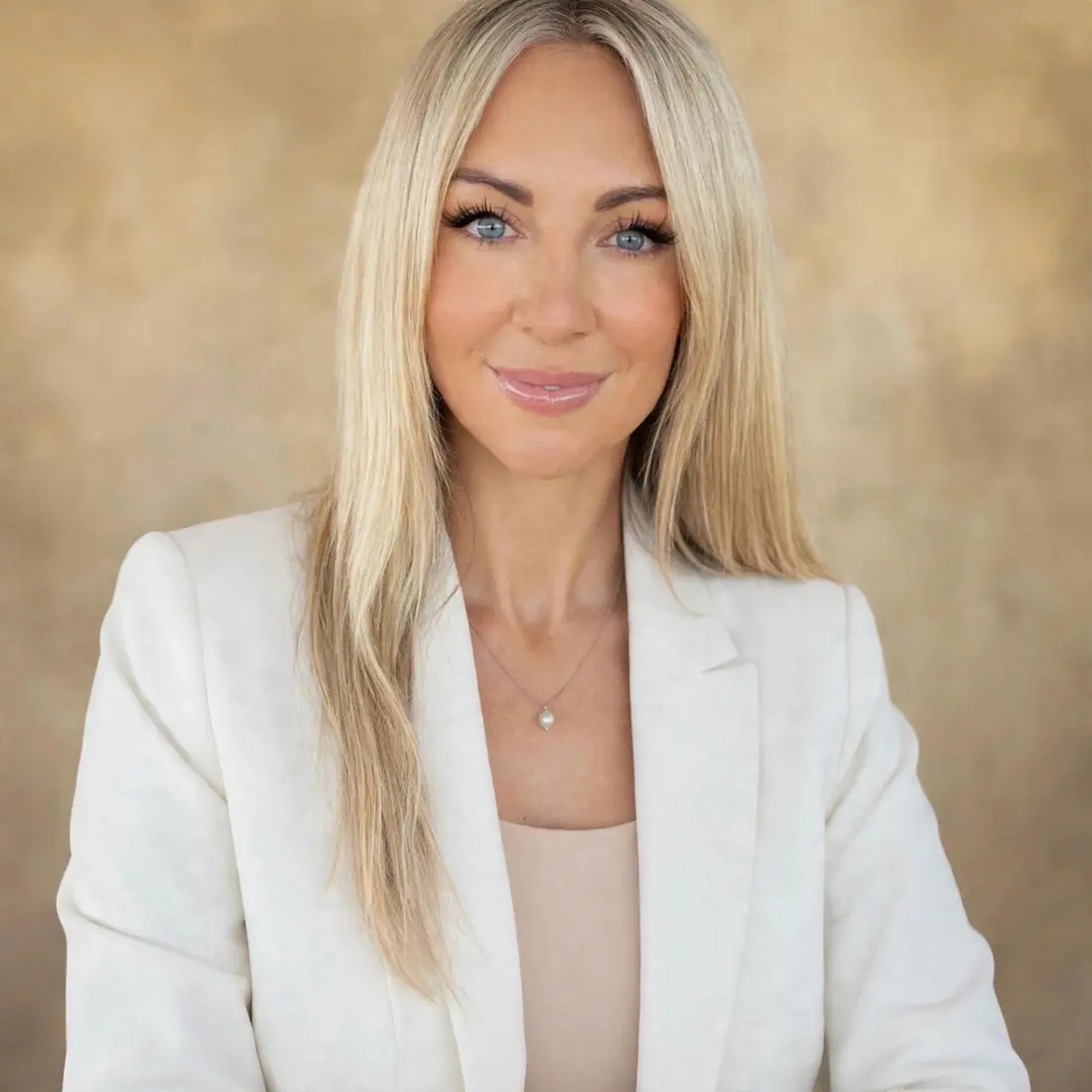 Melissa Brooke, co-founder and licensee of Best Invest, in a white blazer against a warm backdrop