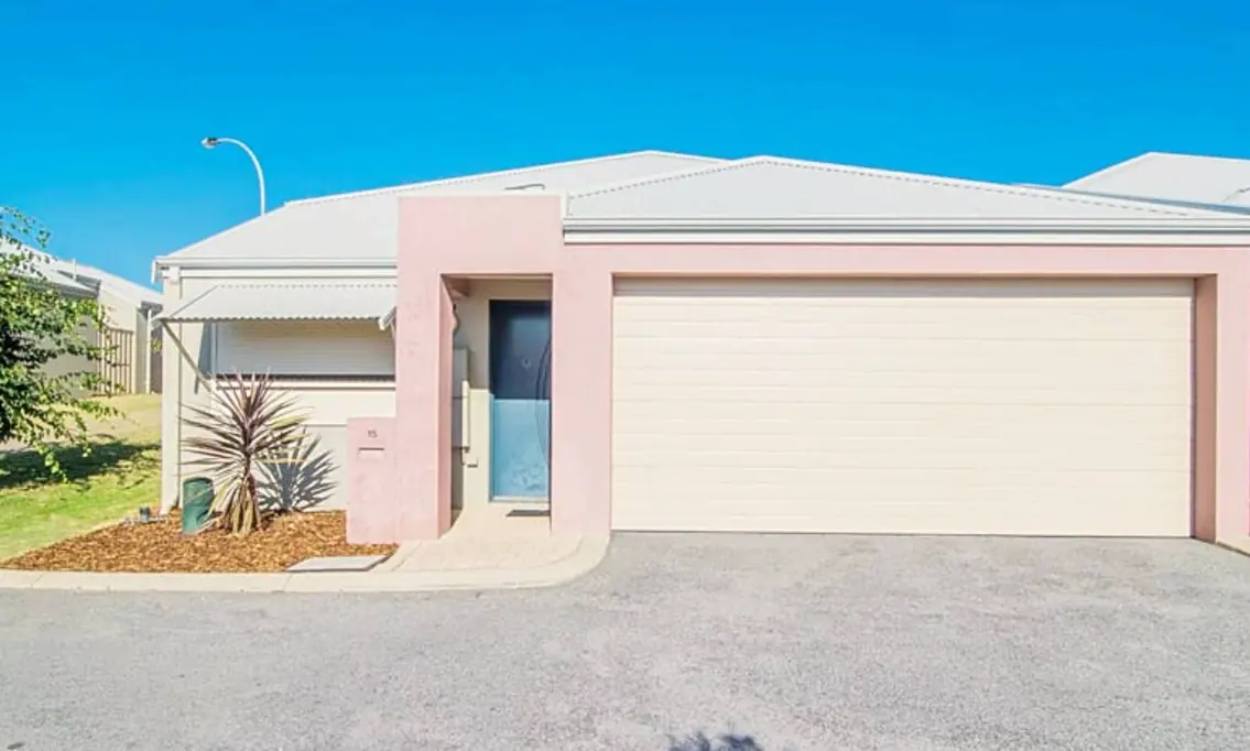 The guarantor purchase, a pink rendered villa with a double garage on a quiet street