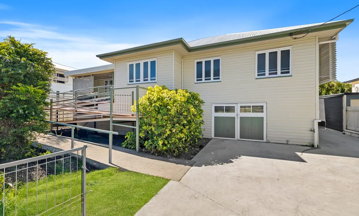 The regional Queensland purchase, a raised weatherboard home with a side deck and a carport underneath